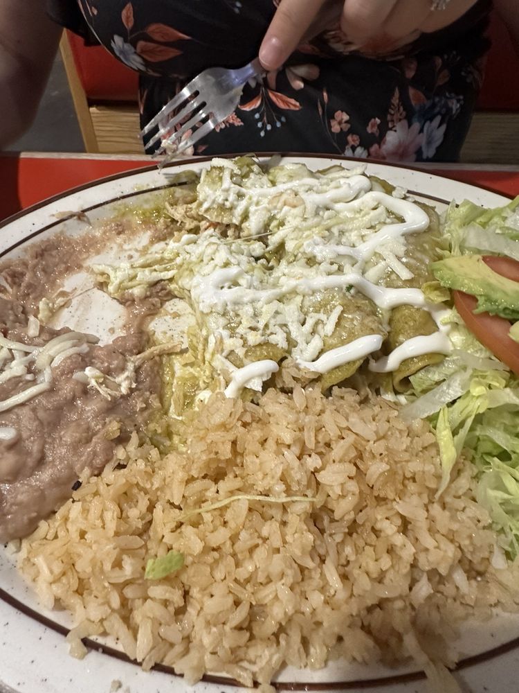 Real public photo of green chicken enchiladas at La Lupita